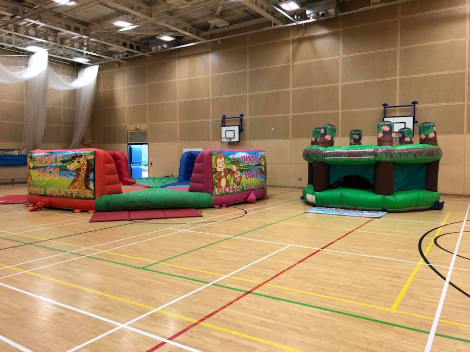 This image shows two of SJ's Leisure's fantastic inflatable products An image of the inflatable Whack-A-Mole and inflatable hungry hippos game